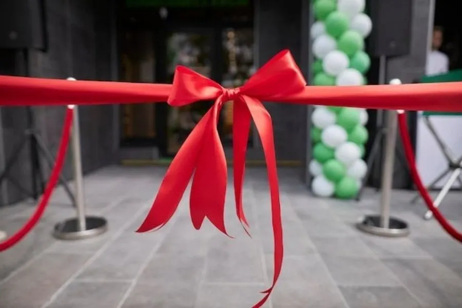 Red ribbon cutting ceremony symbolizing a significant company milestone, achievement, and the continuous growth and expansion of MaxxGro's agrochemical business.